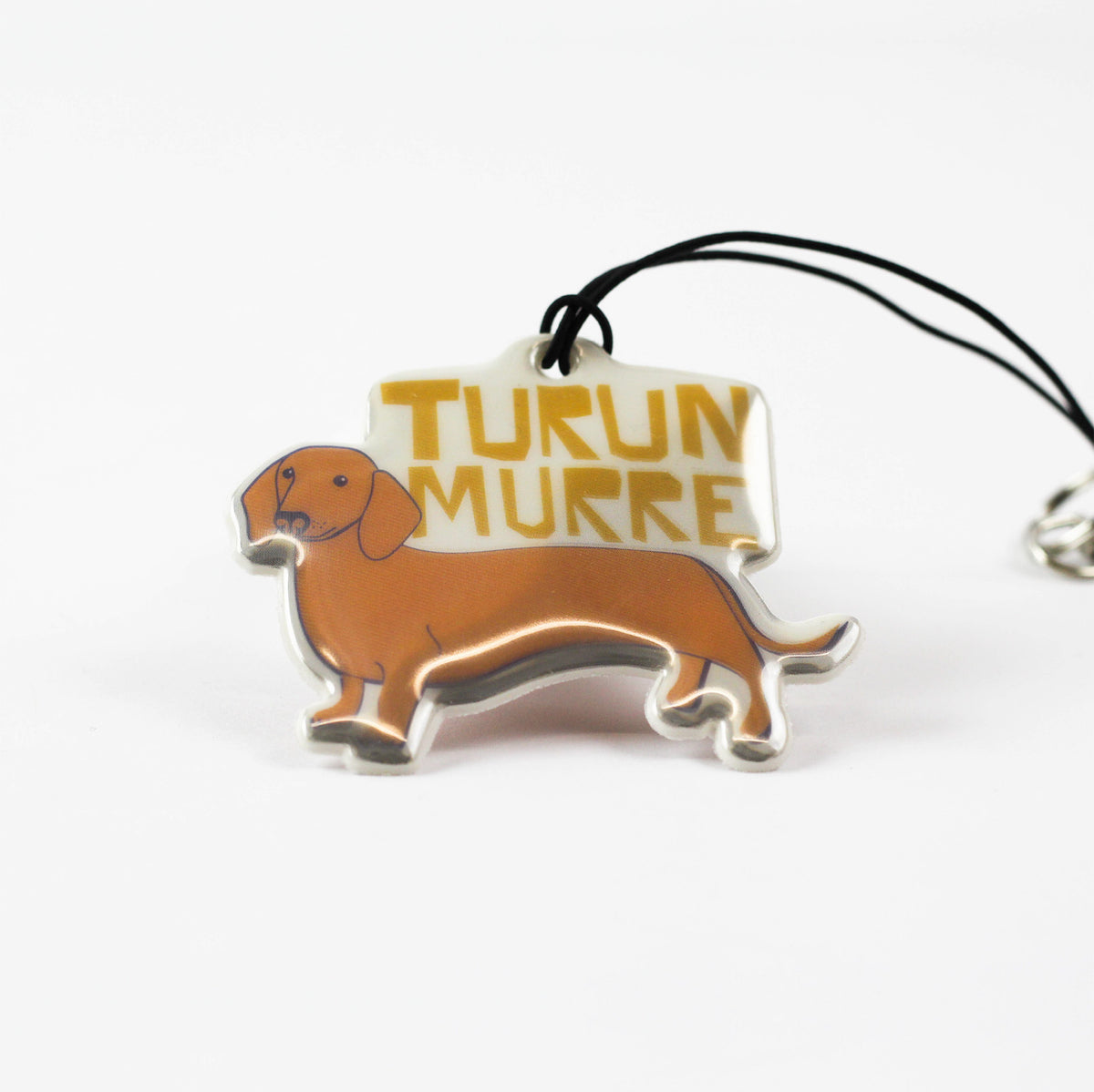 Kui designin Turun murre-heijastin. Mäyräkoiran kuva.